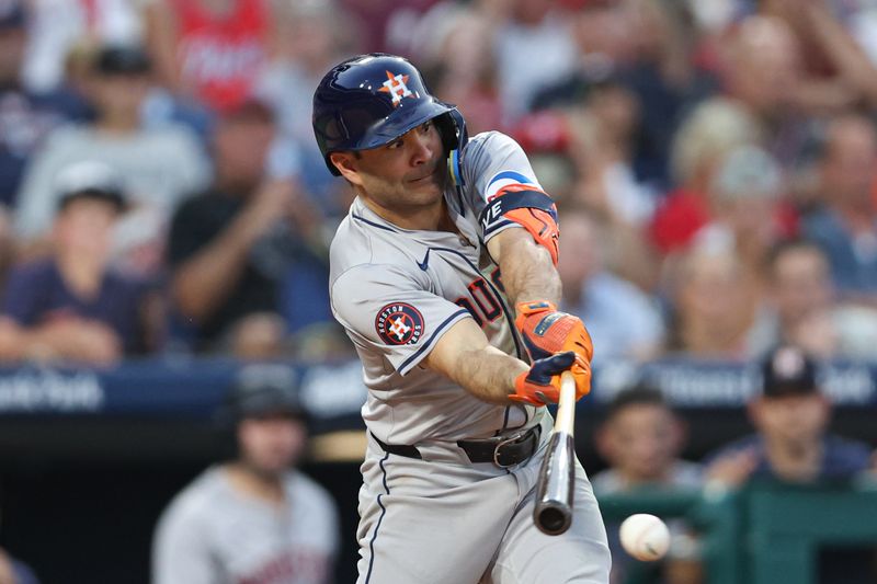 Aug 27, 2024; Philadelphia, Pennsylvania, USA; Houston Astros second base Jose Altuve (27) hits a single against the Philadelphia Phillies during the third inning at Citizens Bank Park. Mandatory Credit: Bill Streicher-USA TODAY Sports