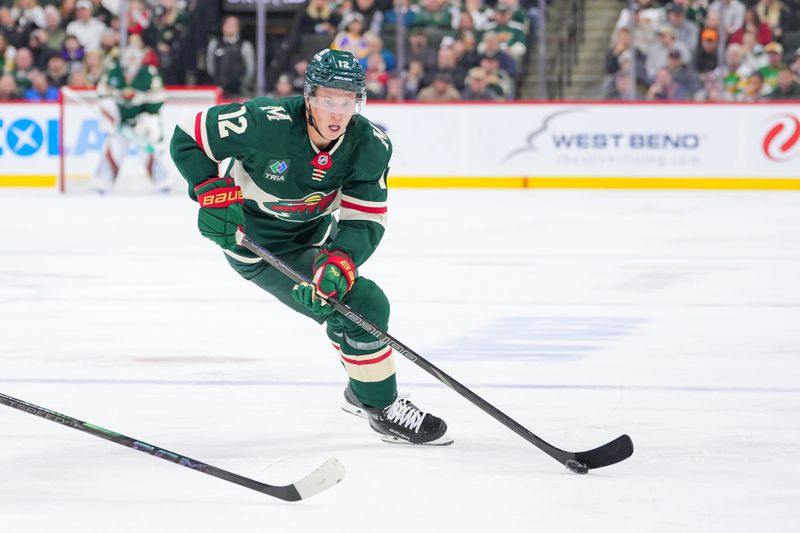 Nov 5, 2024; Saint Paul, Minnesota, USA; Minnesota Wild left wing Matt Boldy (12) skates with the puck against the Los Angeles Kings in the second period at Xcel Energy Center. Mandatory Credit: Brad Rempel-Imagn Images