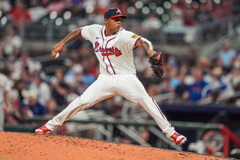 Jul 3, 2024; Cumberland, Georgia, USA; Atlanta Braves relief pitcher Raisel Iglesias (26) pitches against the San Francisco Giants during the ninth inning at Truist Park. Mandatory Credit: Dale Zanine-USA TODAY Sports