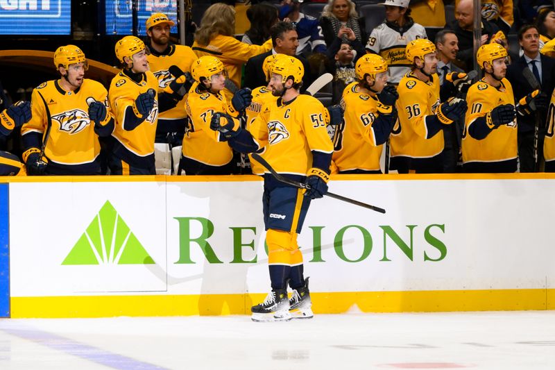 Nov 29, 2024; Nashville, Tennessee, USA;  Nashville Predators defenseman Roman Josi (59) celebrates his goal with his teammates  against the Tampa Bay Lightning during the first period at Bridgestone Arena. Mandatory Credit: Steve Roberts-Imagn Images