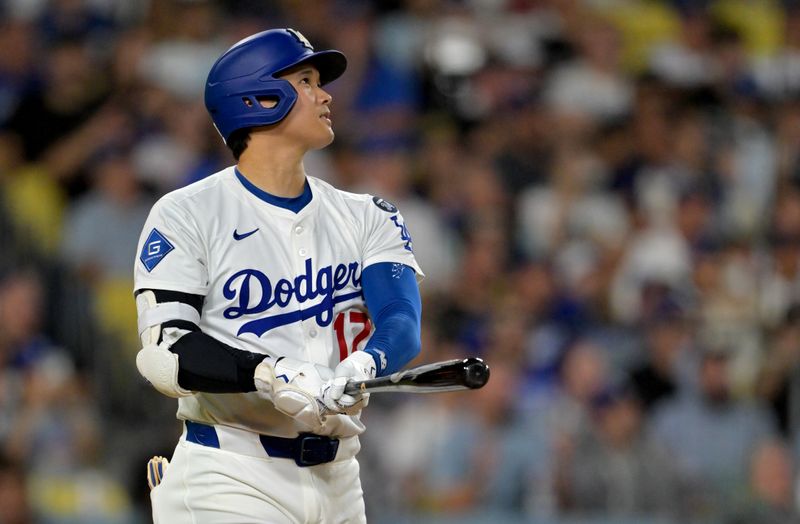 Sep 17, 2025; Los Angeles, California, USA;  Los Angeles Dodgers designated hitter Shohei Ohtani (17) watches the flight of the ball on his 51st home run of the season in the eighth inning against the Philadelphia Phillies at Dodger Stadium. Mandatory Credit: Jayne Kamin-Oncea-Imagn Images
