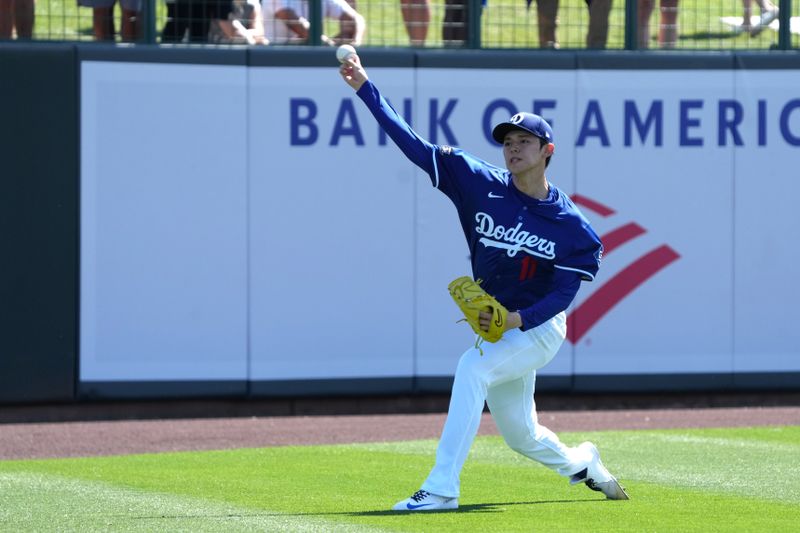 Mar 11, 2025; Phoenix, Arizona, USA; Los Angeles Dodgers pitcher Roki Sasaki (11) warms up before a game against the Cleveland Guardians at Camelback Ranch-Glendale. Mandatory Credit: Rick Scuteri-Imagn Images