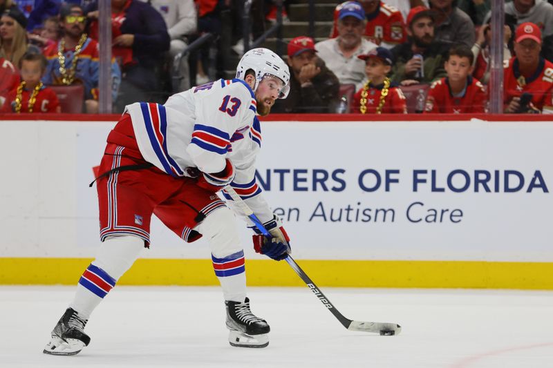 May 26, 2024; Sunrise, Florida, USA; New York Rangers left wing Alexis Lafrenière (13) moves the puck against the Florida Panthers during the second period in game three of the Eastern Conference Final of the 2024 Stanley Cup Playoffs at Amerant Bank Arena. Mandatory Credit: Sam Navarro-USA TODAY Sports