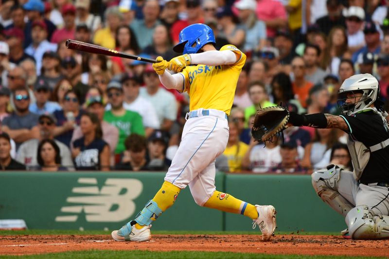 Aug 24, 2024; Boston, Massachusetts, USA;  Boston Red Sox catcher Connor Wong (12) hits a single during the fifth inning against the Arizona Diamondbacks at Fenway Park. Mandatory Credit: Bob DeChiara-USA TODAY Sports