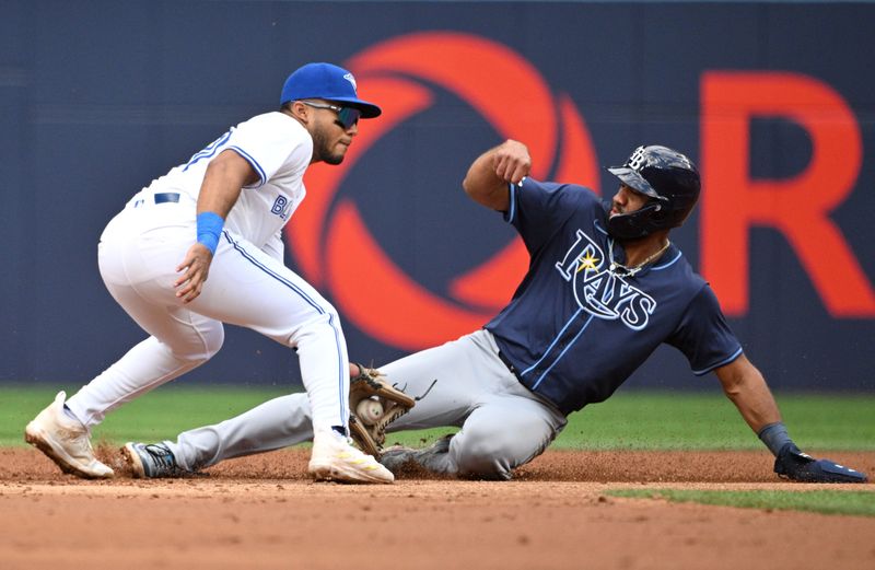 Jul 25, 2024; Toronto, Ontario, CAN;  Tampa Bay Rays third baseman Ahmed Rosario (10) steals second base against Toronto Blue Jays shortstop Leo Jimenez (45) in the second inning at Rogers Centre. Mandatory Credit: Dan Hamilton-USA TODAY Sports