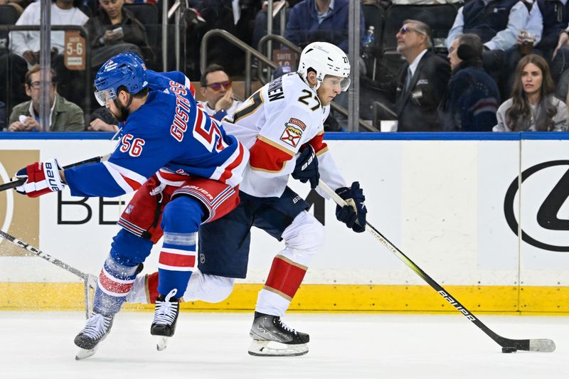 May 30, 2024; New York, New York, USA; New York Rangers defenseman Erik Gustafsson (56) attempts a hit on Florida Panthers center Eetu Luostarinen (27) during the second period in game five of the Eastern Conference Final of the 2024 Stanley Cup Playoffs at Madison Square Garden. Mandatory Credit: Dennis Schneidler-USA TODAY Sports