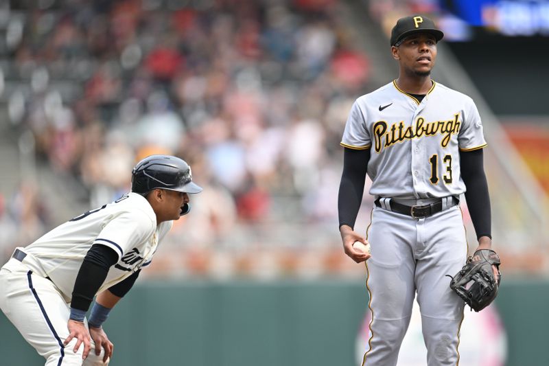 Aug 20, 2023; Minneapolis, Minnesota, USA; Pittsburgh Pirates third baseman Ke'Bryan Hayes (13) reacts after a single by Minnesota Twins shortstop Carlos Correa (not pictured) advances first baseman Donovan Solano (left) to third base during the fourth inning at Target Field. Mandatory Credit: Jeffrey Becker-USA TODAY Sports