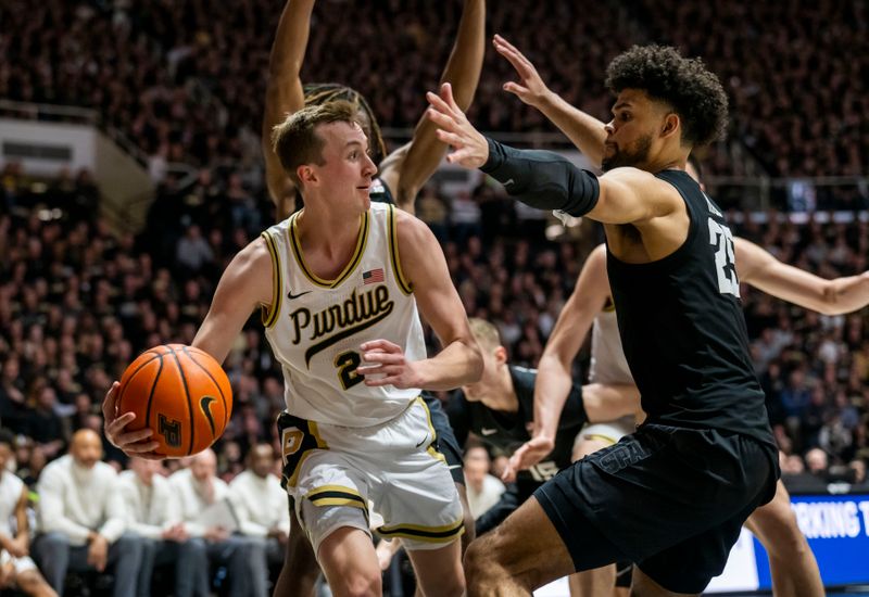 Mar 2, 2024; West Lafayette, Indiana, USA; Purdue Boilermakers guard Fletcher Loyer (2) passes the ball away from Michigan State Spartans forward Malik Hall (25) under the basket during the second half at Mackey Arena. Mandatory Credit: Marc Lebryk-USA TODAY Sports
