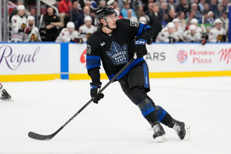 Dec 2, 2024; Toronto, Ontario, CAN; Toronto Maple Leafs defenseman Philippe Myers (51) skates against the Chicago Blackhawks during the second period at Scotiabank Arena. Mandatory Credit: John E. Sokolowski-Imagn Images