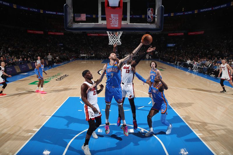 OKLAHOMA CITY, OK - MARCH 8:  Chet Holmgren #7 of the Oklahoma City Thunder grabs a rebound during the game against the Miami Heat on March 8, 2024 at Paycom Arena in Oklahoma City, Oklahoma. NOTE TO USER: User expressly acknowledges and agrees that, by downloading and or using this photograph, User is consenting to the terms and conditions of the Getty Images License Agreement. Mandatory Copyright Notice: Copyright 2024 NBAE (Photo by Zach Beeker/NBAE via Getty Images)