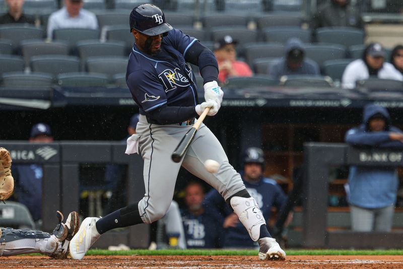 May 4, 2025; Bronx, New York, USA; Tampa Bay Rays first baseman Yandy Diaz (2) hits an infield single during the fourth inning against the New York Yankees at Yankee Stadium. Mandatory Credit: Vincent Carchietta-Imagn Images