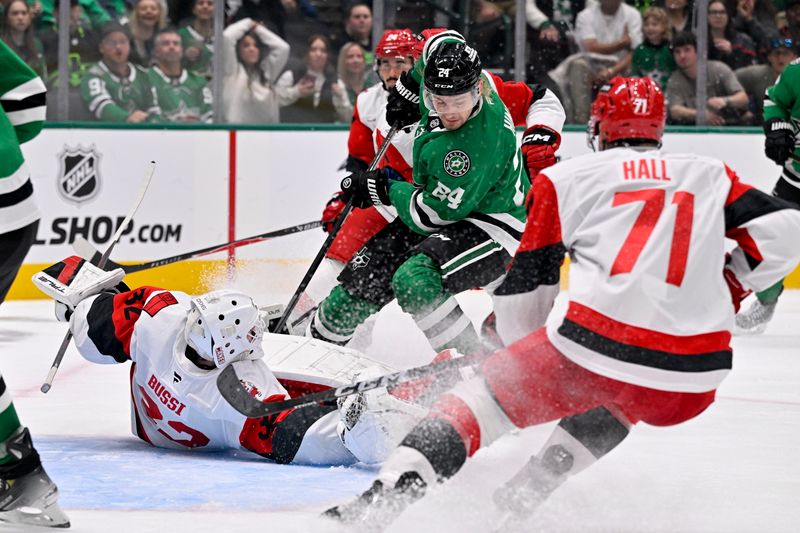 Oct 25, 2025; Dallas, Texas, USA; Carolina Hurricanes goaltender Brandon Bussi (32) stops a shot by Dallas Stars center Roope Hintz (24) during the second period at the American Airlines Center. Mandatory Credit: Jerome Miron-Imagn Images