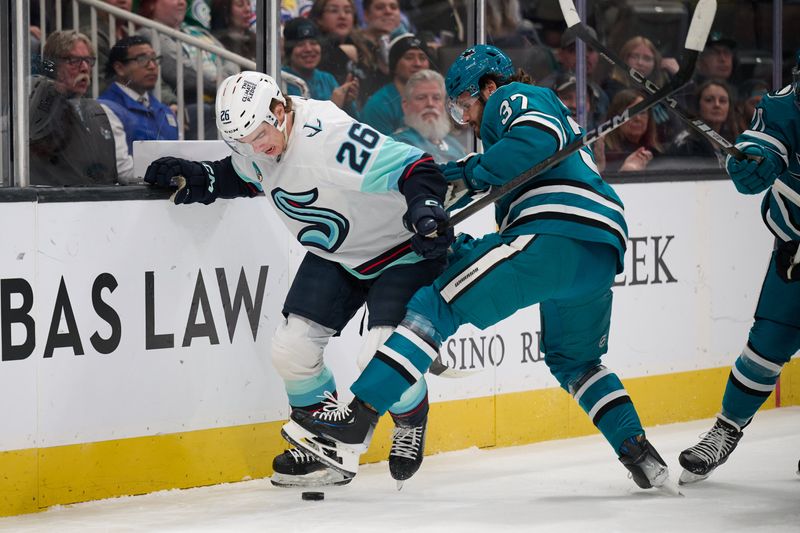 Nov 29, 2024; San Jose, California, USA; Seattle Kraken center Ryan Winterton (26) controls the puck against San Jose Sharks defenseman Timothy Liljegren (37) during the first period at SAP Center at San Jose. Mandatory Credit: Robert Edwards-Imagn Images