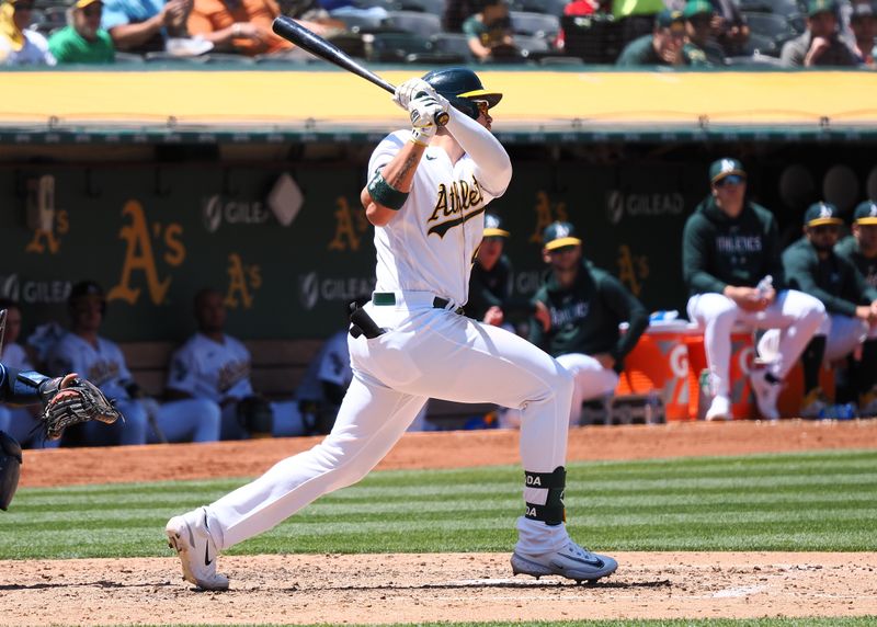 Jun 15, 2023; Oakland, California, USA; Oakland Athletics first baseman Ryan Noda (49) hits an RBI single against the Tampa Bay Rays during the fifth inning at Oakland-Alameda County Coliseum. Mandatory Credit: Kelley L Cox-USA TODAY Sports