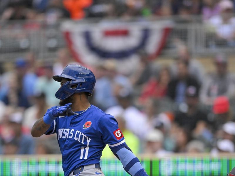 May 27, 2024; Minneapolis, Minnesota, USA; Kansas City Royals infielder Maikel Garcia (11) hits a single against the Minnesota Twins during the eighth inning at Target Field. Mandatory Credit: Nick Wosika-USA TODAY Sports