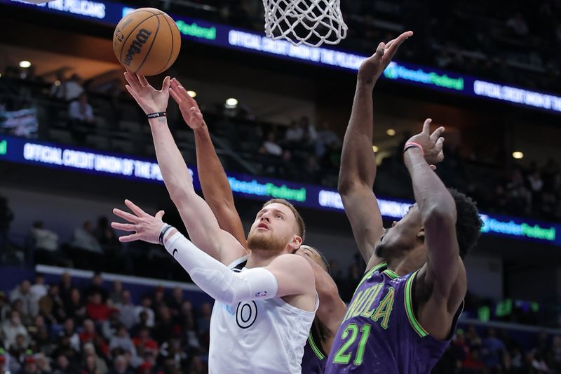 NEW ORLEANS, LOUISIANA - JANUARY 07: Donte DiVincenzo #0 of the Minnesota Timberwolves shoots against Yves Missi #21 of the New Orleans Pelicans during the second half at the Smoothie King Center on January 07, 2025 in New Orleans, Louisiana. NOTE TO USER: User expressly acknowledges and agrees that, by downloading and or using this Photograph, user is consenting to the terms and conditions of the Getty Images License Agreement. (Photo by Jonathan Bachman/Getty Images)