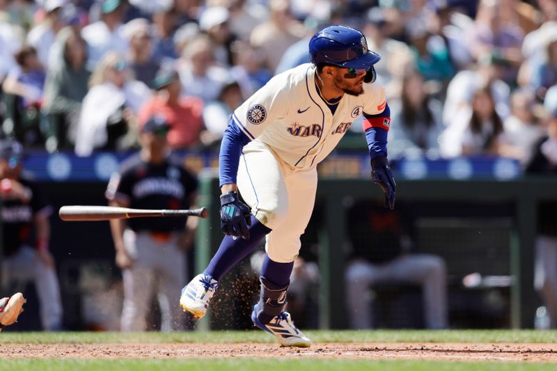 Jun 1, 2025; Seattle, Washington, USA; Seattle Mariners center fielder Julio Rodríguez (44) hits a single against the Minnesota Twins during the ninth inning at T-Mobile Park. Mandatory Credit: John Froschauer-Imagn Images