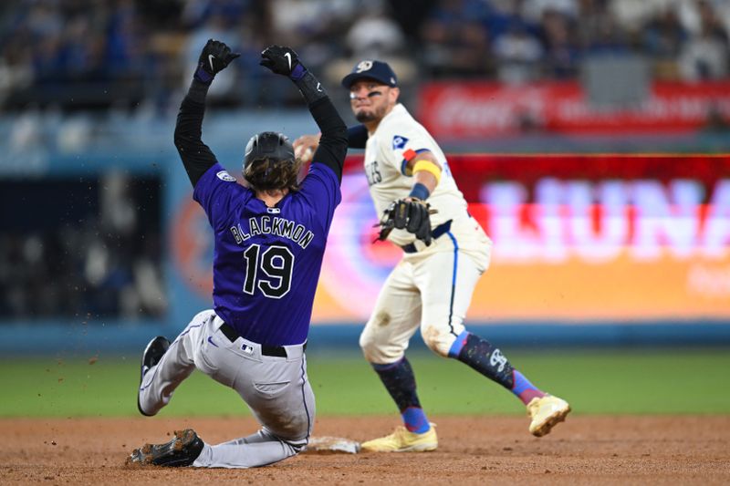 Sep 21, 2024; Los Angeles, California, USA; Los Angeles Dodgers shortstop Miguel Rojas (11) forces out Colorado Rockies designated hitter Charlie Blackmon (19) and throws to first base for a double play against the Colorado Rockies during the seventh inning at Dodger Stadium. Mandatory Credit: Jonathan Hui-Imagn Images