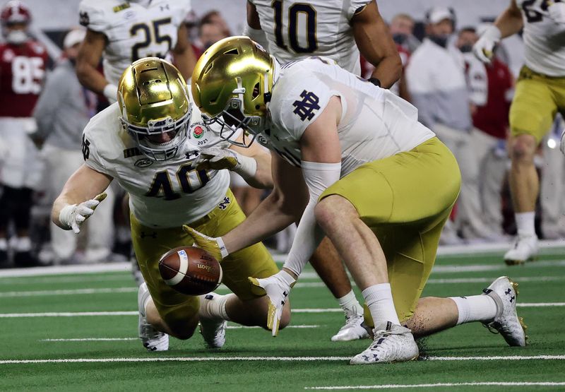 Jan 1, 2021; Arlington, TX, USA; Notre Dame Fighting Irish linebacker Drew White (40) downs the ball on the one yard line after a punt against the Alabama Crimson Tide during the first half in the Rose Bowl at AT&T Stadium. Mandatory Credit: Kevin Jairaj-USA TODAY Sports