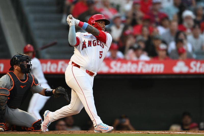 Jun 29, 2024; Anaheim, California, USA; Los Angeles Angels designated hitter Willie Calhoun (5) doubles against the Detroit Tigers during the second inning at Angel Stadium. Mandatory Credit: Jonathan Hui-USA TODAY Sports