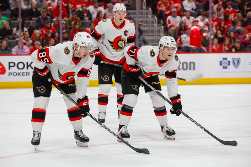 Dec 9, 2023; Detroit, Michigan, USA; Ottawa Senators defenseman Jake Sanderson (85) center Ridly Greig (71) and Ottawa Senators left wing Brady Tkachuk (7) look on during the second period at Little Caesars Arena. Mandatory Credit: Brian Bradshaw Sevald-USA TODAY Sports