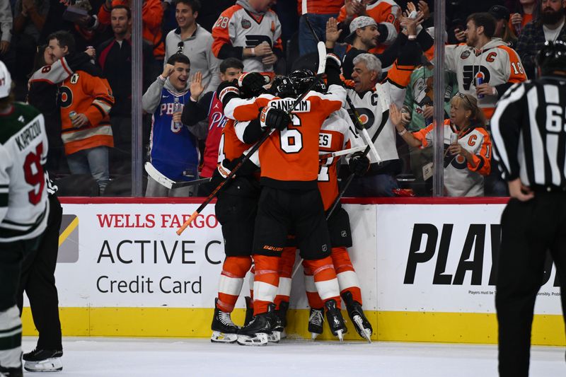 Oct 26, 2024; Philadelphia, Pennsylvania, USA; Philadelphia Flyers center Sean Couturier (14) celebrates with teammates after scoring a hat trick goal against the Minnesota Wild in the third period at Wells Fargo Center. Mandatory Credit: Kyle Ross-Imagn Images