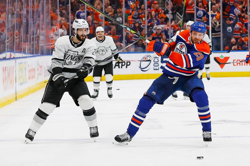 May 1, 2024; Edmonton, Alberta, CAN; Los Angeles Kings forward Phillip Danault (24) hooks Edmonton Oilers forward Leon Draisaitl (29) during the third period in game five of the first round of the 2024 Stanley Cup Playoffs at Rogers Place. Mandatory Credit: Perry Nelson-USA TODAY Sports