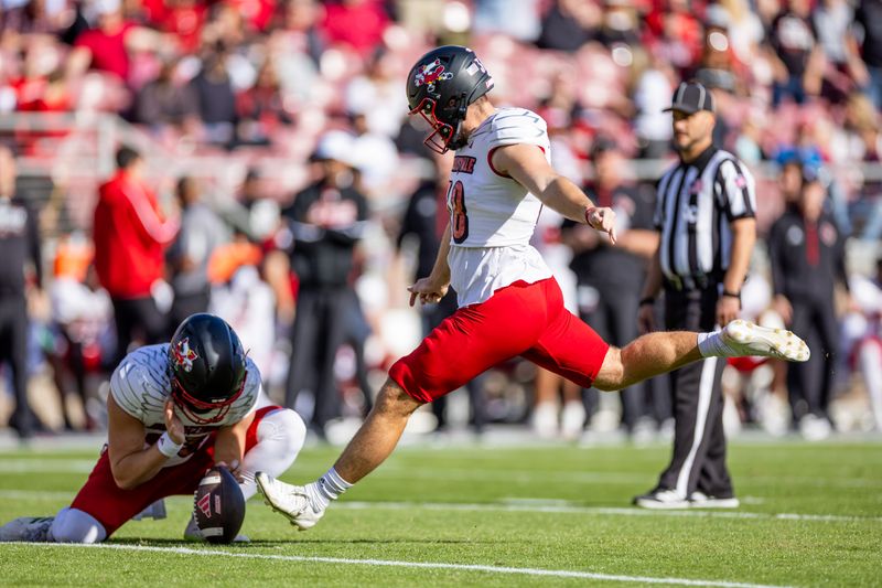 Nov 16, 2024; Stanford, California, USA;  Louisville Cardinals place kicker Brock Travelstead (38) kicks a PAT during the first quarter against the Stanford Cardinal at Stanford Stadium. Mandatory Credit: Bob Kupbens-Imagn Images