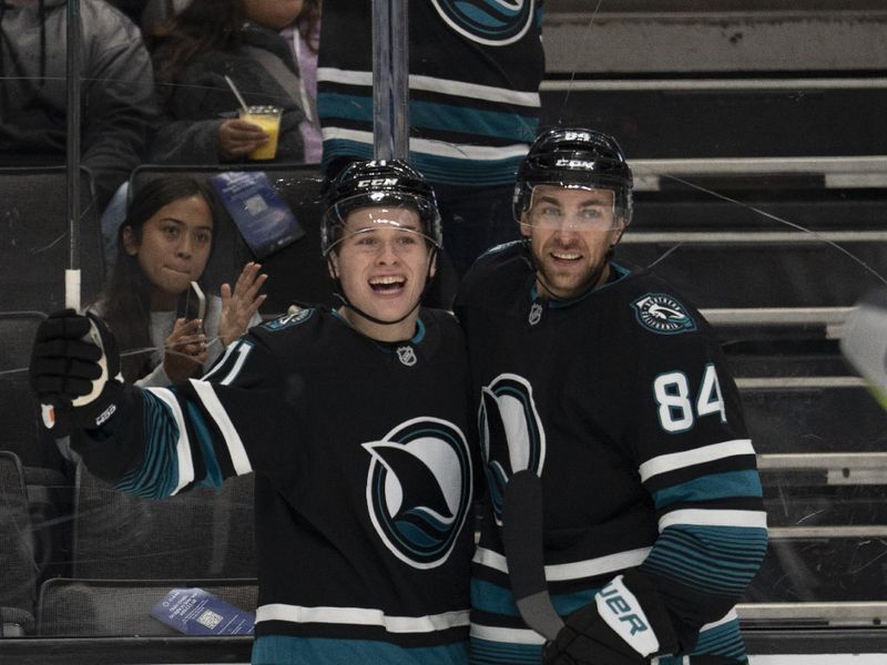 Nov 7, 2024; San Jose, California, USA;  San Jose Sharks center Macklin Celebrini (71) reacts with defenseman Jan Rutta (84) after scoring a goal during the second period against the Minnesota Wild at SAP Center at San Jose. Mandatory Credit: Stan Szeto-Imagn Images