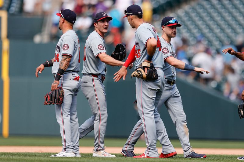 Jun 23, 2024; Denver, Colorado, USA; Washington Nationals center fielder Jacob Young (30) and right fielder Lane Thomas (28) celebrate with left fielder Ildemaro Vargas (14) and first baseman Joey Meneses (45) after the game against the Colorado Rockies at Coors Field. Mandatory Credit: Isaiah J. Downing-USA TODAY Sports