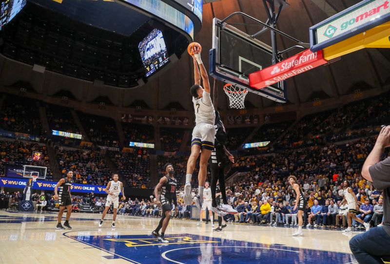 Jan 31, 2024; Morgantown, West Virginia, USA; West Virginia Mountaineers center Jesse Edwards (7) dunks the ball during the second half against the Cincinnati Bearcats at WVU Coliseum. Mandatory Credit: Ben Queen-USA TODAY Sports