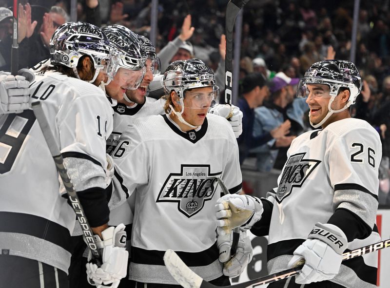 Apr 10, 2023; Los Angeles, California, USA;  Los Angeles Kings right wing Arthur Kaliyev (34), second from left, celebrates after scoring a goal in the second period against the Vancouver Canucks at Crypto.com Arena. Mandatory Credit: Jayne Kamin-Oncea-USA TODAY Sports