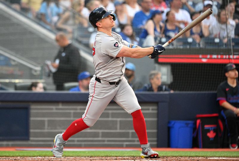 Jun 17, 2024; Toronto, Ontario, CAN;  Boston Red Sox designated hitter Tyler O'Neill (17) hits a solo home run against the Toronto Blue Jays in the third inning at Rogers Centre. Mandatory Credit: Dan Hamilton-USA TODAY Sports