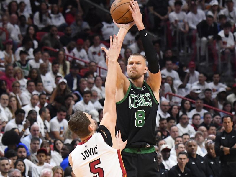 MIAMI, FL - APRIL 27: Kristaps Porzingis #8 of the Boston Celtics shoots a three point basket against the Miami Heat during Round 1 Game 3 of the 2024 NBA Playoffs on April 27, 2024 at Kaseya Center in Miami, Florida. NOTE TO USER: User expressly acknowledges and agrees that, by downloading and or using this Photograph, user is consenting to the terms and conditions of the Getty Images License Agreement. Mandatory Copyright Notice: Copyright 2024 NBAE (Photo by Brian Babineau/NBAE via Getty Images)