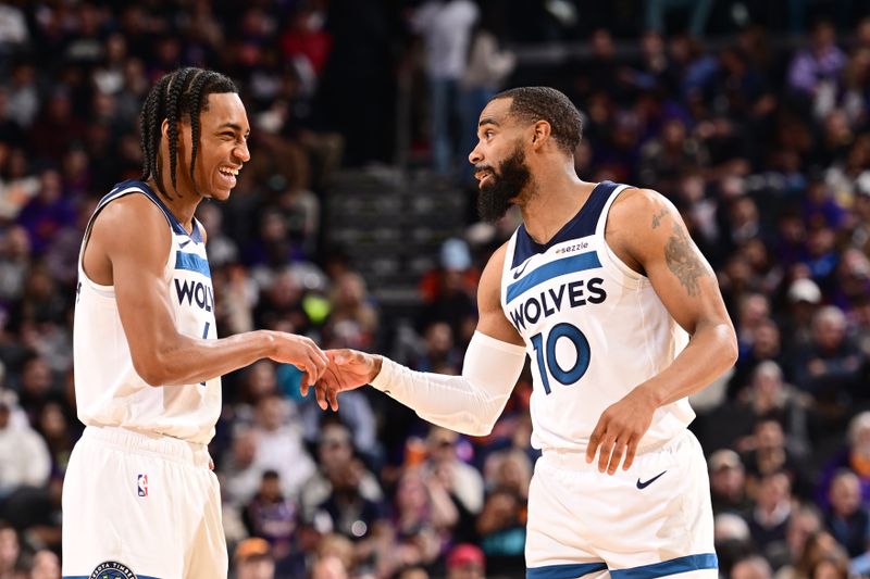 PHOENIX, AZ - JANUARY 29: Rob Dillingham #4 and Mike Conley #10 of the Minnesota Timberwolves high five during the game against the Phoenix Suns on January 29, 2025 at Footprint Center in Phoenix, Arizona. NOTE TO USER: User expressly acknowledges and agrees that, by downloading and or using this photograph, user is consenting to the terms and conditions of the Getty Images License Agreement. Mandatory Copyright Notice: Copyright 2025 NBAE (Photo by Kate Frese/NBAE via Getty Images)