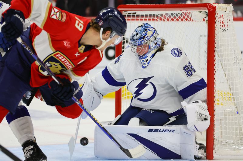 Apr 21, 2024; Sunrise, Florida, USA; Tampa Bay Lightning goaltender Andrei Vasilevskiy (88) makes a save against Florida Panthers left wing Matthew Tkachuk (19) during the first period in game one of the first round of the 2024 Stanley Cup Playoffs at Amerant Bank Arena. Mandatory Credit: Sam Navarro-USA TODAY Sports