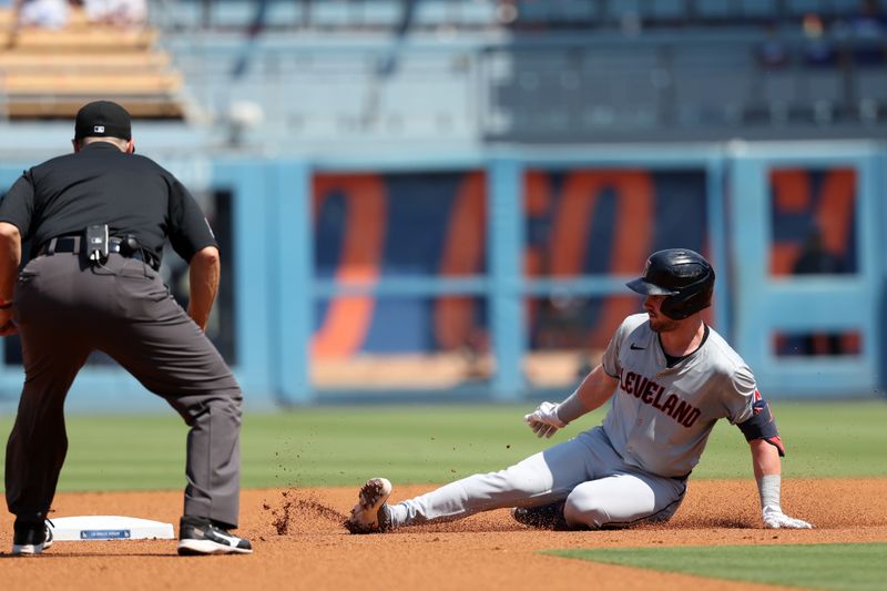 Sep 8, 2024; Los Angeles, California, USA;  Cleveland Guardians right fielder Lane Thomas (8) slides to a second base after Los Angeles Dodgers center fielder Andy Pages (44, not pictured) made an error during the second inning at Dodger Stadium. Mandatory Credit: Kiyoshi Mio-Imagn Images