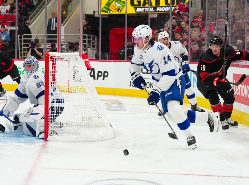 Oct 11, 2024; Raleigh, North Carolina, USA;  Tampa Bay Lightning center Conor Geekie (14) skates with the puck against the Carolina Hurricanes during the third period at PNC Arena. Mandatory Credit: James Guillory-Imagn Images