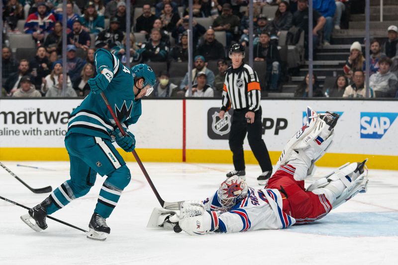 Jan 23, 2024; San Jose, California, USA; New York Rangers goaltender Igor Shesterkin (31) dives towards the puck during the second period against San Jose Sharks left wing Alexander Barabanov (94) at SAP Center at San Jose. Mandatory Credit: Stan Szeto-USA TODAY Sports