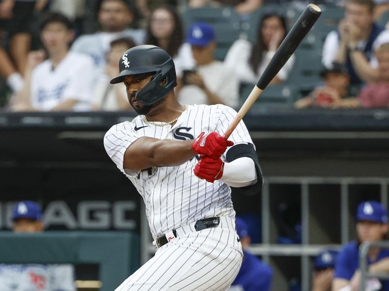 Jun 25, 2024; Chicago, Illinois, USA; Chicago White Sox designated hitter Eloy Jiménez (74) hits an RBI-double against the Los Angeles Dodgers during the first inning at Guaranteed Rate Field. Mandatory Credit: Kamil Krzaczynski-USA TODAY Sports