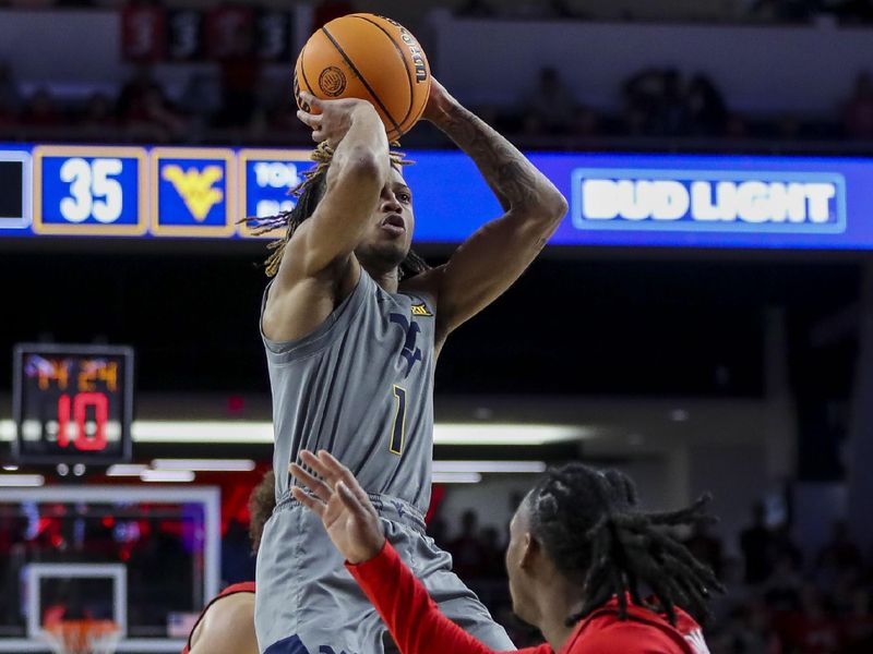 Mar 9, 2024; Cincinnati, Ohio, USA; West Virginia Mountaineers guard Noah Farrakhan (1) shoots against Cincinnati Bearcats guard Day Day Thomas (1) in the second half at Fifth Third Arena. Mandatory Credit: Katie Stratman-USA TODAY Sports