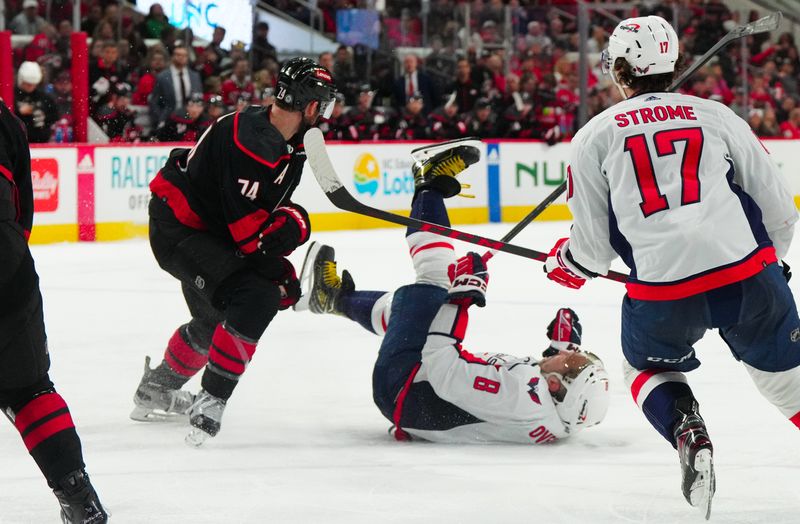 Apr 5, 2024; Raleigh, North Carolina, USA; Carolina Hurricanes defenseman Jaccob Slavin (74) trips Washington Capitals left wing Alex Ovechkin (8) during the second period at PNC Arena. Mandatory Credit: James Guillory-USA TODAY Sports