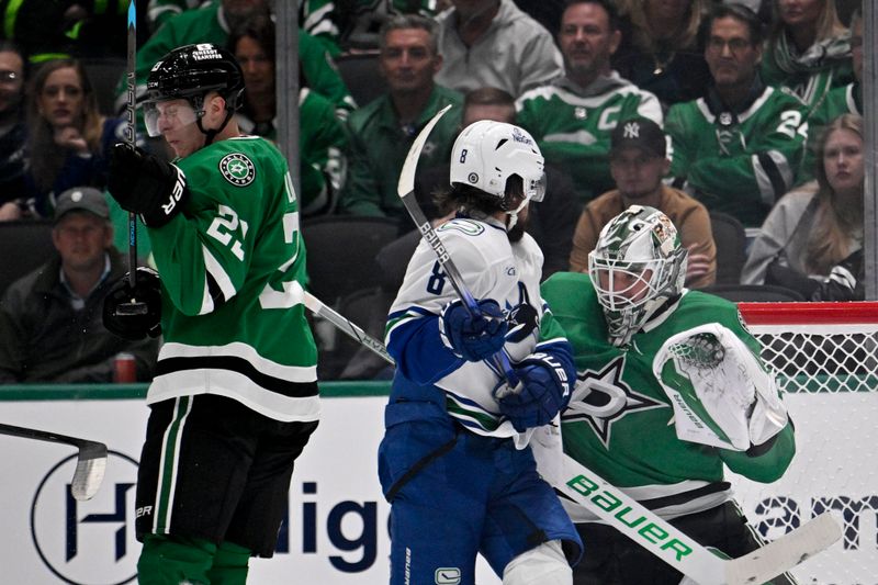 Jan 31, 2025; Dallas, Texas, USA; Dallas Stars goaltender Jake Oettinger (29) stops a shot in front of Vancouver Canucks right wing Conor Garland (8) during the second period at the American Airlines Center. Mandatory Credit: Jerome Miron-Imagn Images