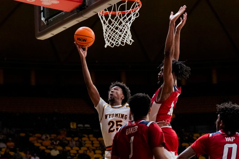 Jan 31, 2023; Laramie, Wyoming, USA; Wyoming Cowboys forward Jeremiah Oden (25) drives against Fresno State Bulldogs forward Isaih Moore (11) during the first half at Arena-Auditorium. Mandatory Credit: Troy Babbitt-USA TODAY Sports