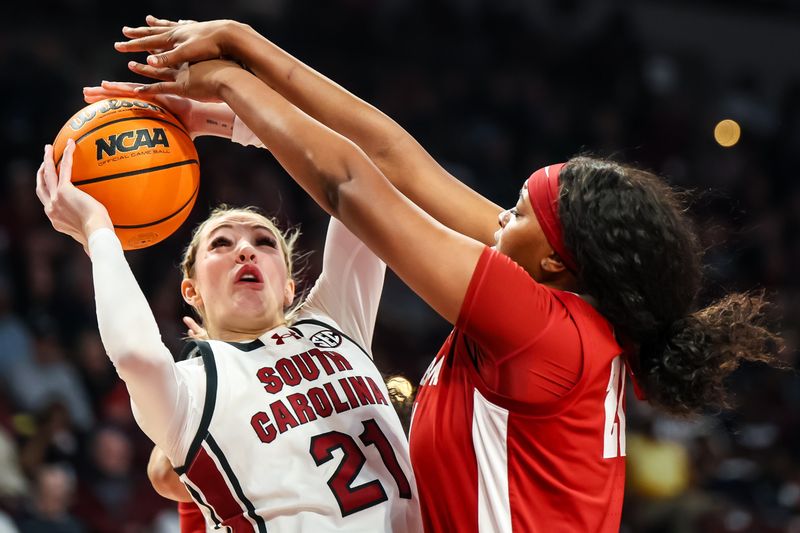 Feb 22, 2024; Columbia, South Carolina, USA; Alabama Crimson Tide forward Essence Cody (21) blocks the shot of South Carolina Gamecocks forward Chloe Kitts (21) in the first half at Colonial Life Arena. Mandatory Credit: Jeff Blake-USA TODAY Sports