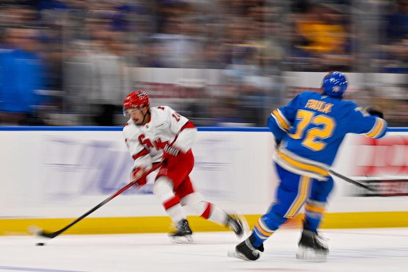 Oct 19, 2024; St. Louis, Missouri, USA;  Carolina Hurricanes center Seth Jarvis (24) controls the puck against the St. Louis Blues during the third period at Enterprise Center. Mandatory Credit: Jeff Curry-Imagn Images