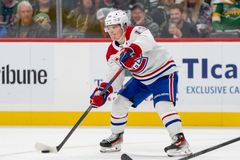 Nov 14, 2024; Saint Paul, Minnesota, USA; Montreal Canadiens right wing Cole Caufield (13) passes the puck on the power play against the Minnesota Wild in the third period at Xcel Energy Center. Mandatory Credit: Matt Blewett-Imagn Images