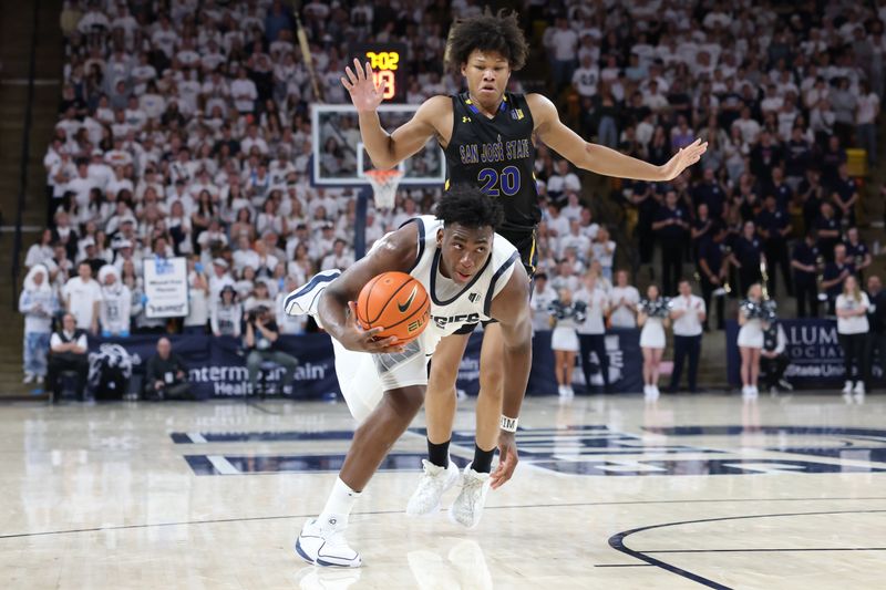 Jan 30, 2024; Logan, Utah, USA; Utah State Aggies forward Great Osobor (1) is fouled by San Jose State Spartans forward Christian Wise (20) during the second half at Dee Glen Smith Spectrum. Mandatory Credit: Rob Gray-USA TODAY Sports