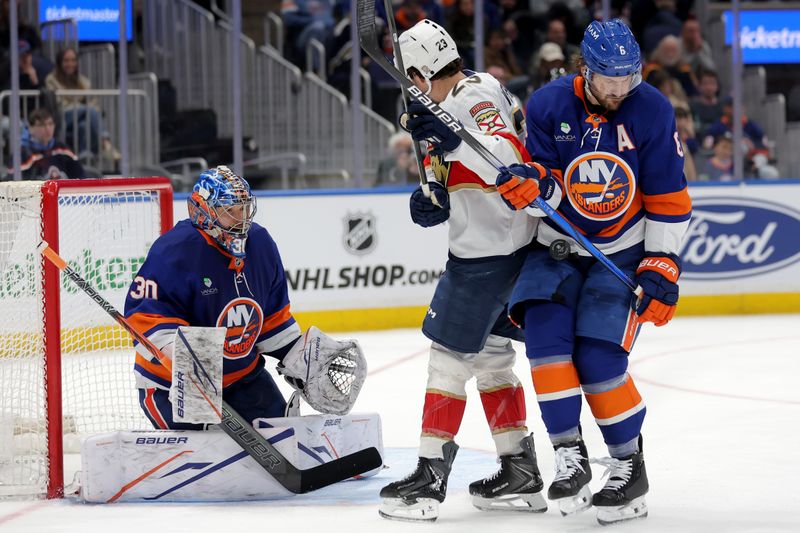 Mar 28, 2026; Elmont, New York, USA; Florida Panthers center Carter Verhaeghe (23) fights for the puck against New York Islanders defenseman Ryan Pulock (6) and goaltender Ilya Sorokin (30) during the third period at UBS Arena. Mandatory Credit: Brad Penner-Imagn Images