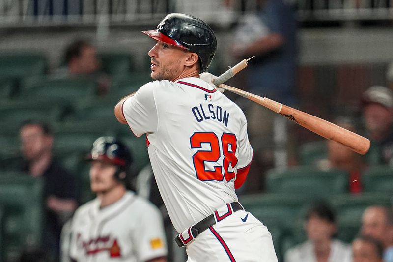 Aug 20, 2024; Cumberland, Georgia, USA; Atlanta Braves first baseman Matt Olson (28) breaks his bat while grounding into a fielders choice against the Philadelphia Phillies during the eighth inning at Truist Park. Mandatory Credit: Dale Zanine-USA TODAY Sports